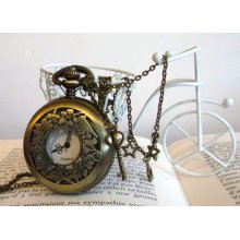 Birdcage pocket watch with 3 little stars and a skeleton key charms over a long brass chain.