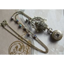 Ornate bronze pocket watch pendant with blue floral cloisonnÃ© beading on chain.