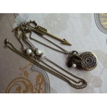 Pocket watch pendant with arrow , crown and mockingjay charms, pearls, brass and Swarovski crystal beads on chain