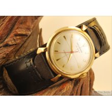 Hallmark 25J vintage wrist watch, water resistant yellow gold filled & stainless steel case, champagne-toned metal dial, leather band